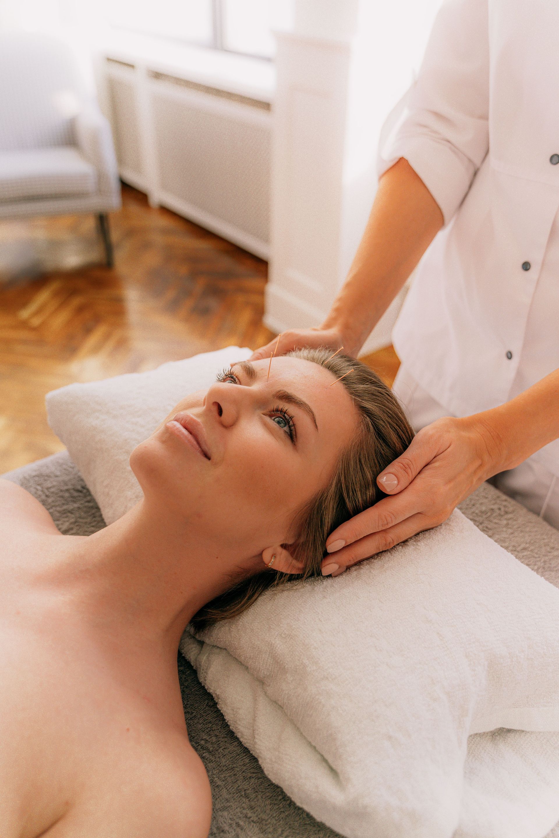 A tranquil moment during a spa session with a woman receiving a relaxing massage. Perfect for wellness themes.